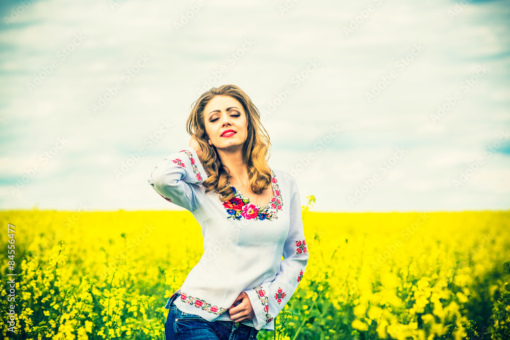 One pretty girl walkin in the yellow field with blue sky One pretty girl walkin in the yellow field with blue sky