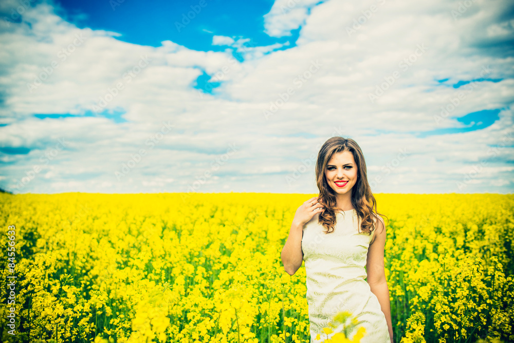One pretty girl walkin in the yellow field with blue sky One pretty girl walkin in the yellow field with blue sky