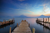 Colorful sunset at the Panajachel Pier with volcanoes in the background, Lake Atitlan, Guatemala, Central America