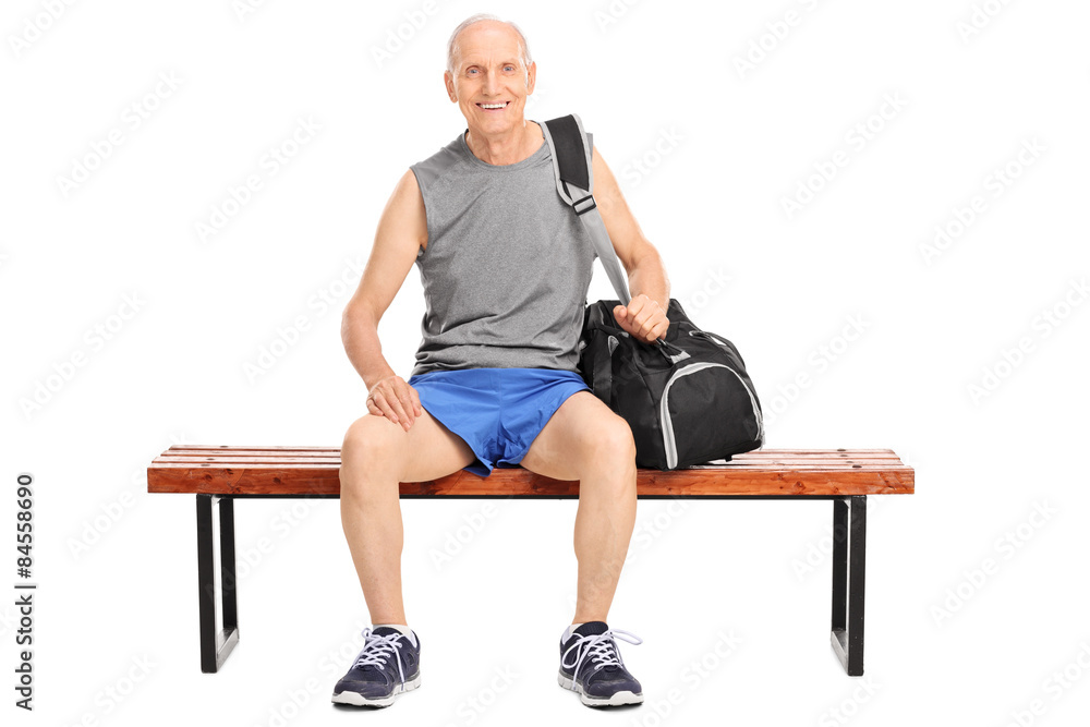 Active senior man sitting on a wooden bench Active senior man sitting on a wooden bench