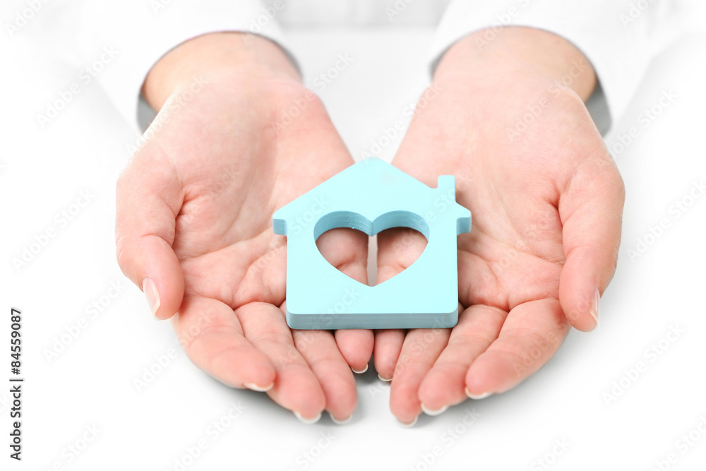Fototapeta premium Female hands holding house, closeup