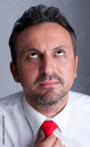 Visionary politician adjusting necktie