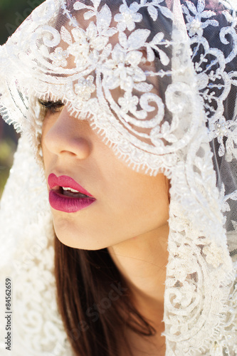 Close-up portrait of a beautiful bride hidden veil