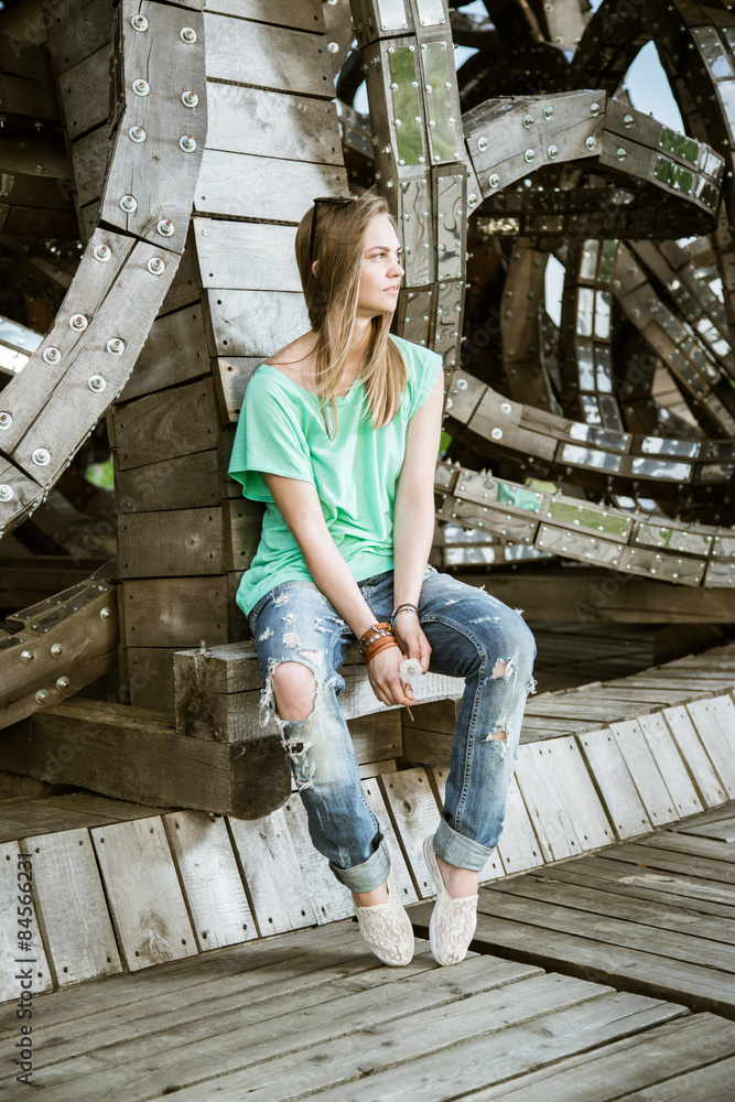 Fototapeta premium Girl posing in wooden structures