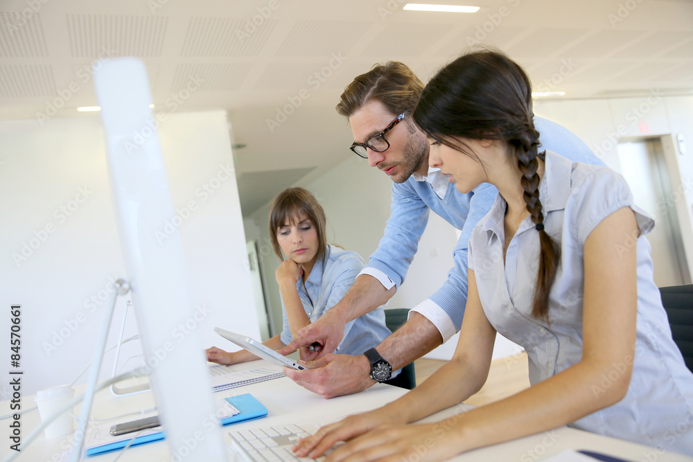Business people working in office on desktop computer Business people working in office on desktop computer