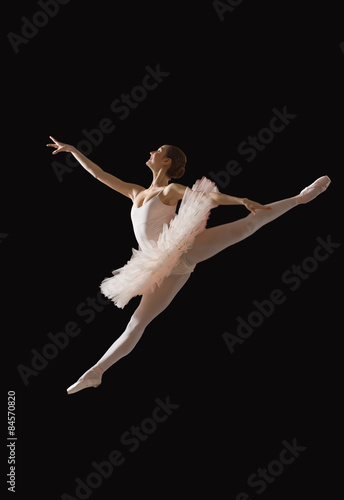 Foto Ballerina in jump isolated onblack