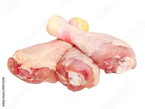 Three uncooked chicken legs.Isolated.