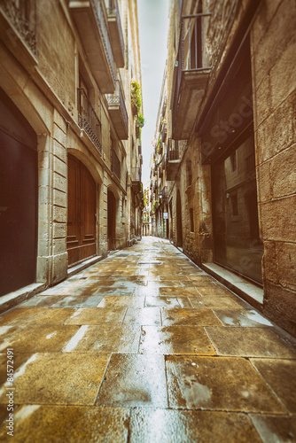 Straight narrow street in Gothic quarter, Barcelona. Vintage