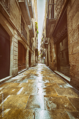 Photography Straight narrow street in Gothic quarter, Barcelona. Vintage