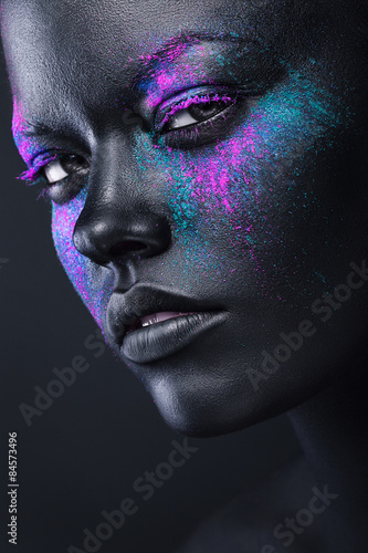 woman in black paint and colourful powder