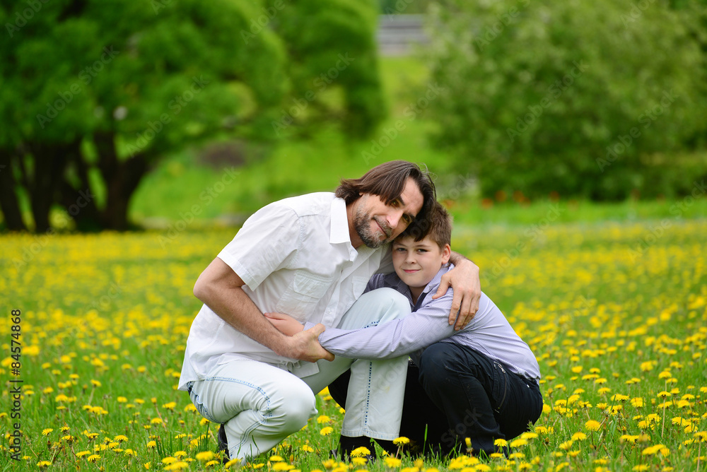 Father and son in summer park Father and son in summer park