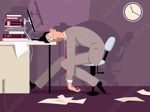 Exhausted man sitting in the office late at night