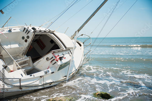 sailboat wrecked and stranded on the beach