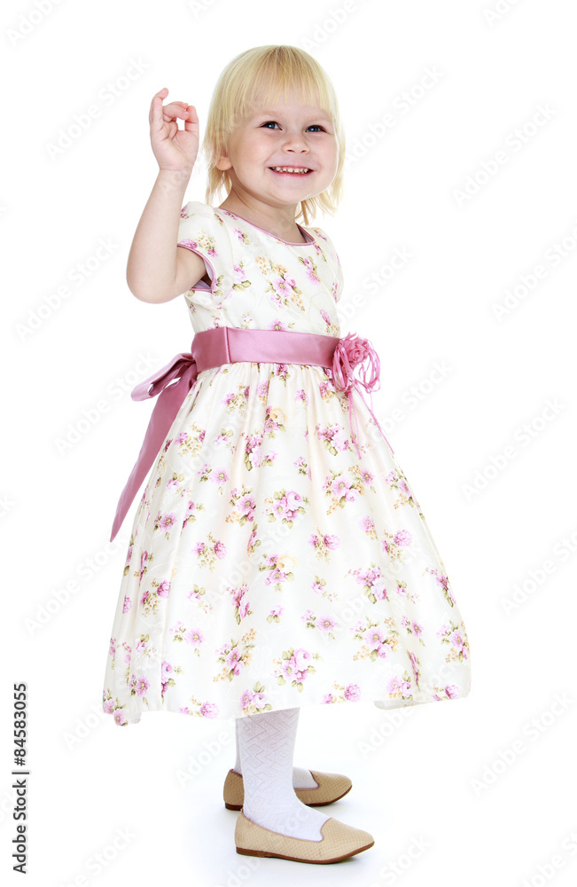 Very gentle little blonde girl in a beautiful long dress Very gentle little blonde girl in a beautiful long dress