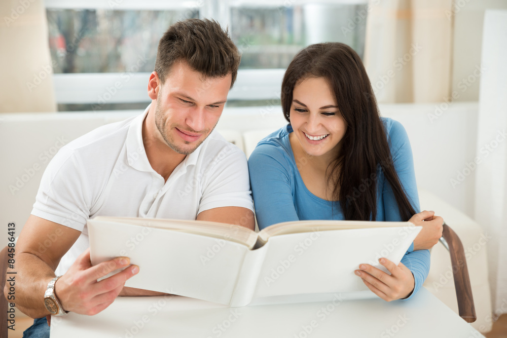 Young Couple Holding Green House Model Young Couple Holding Green House Model