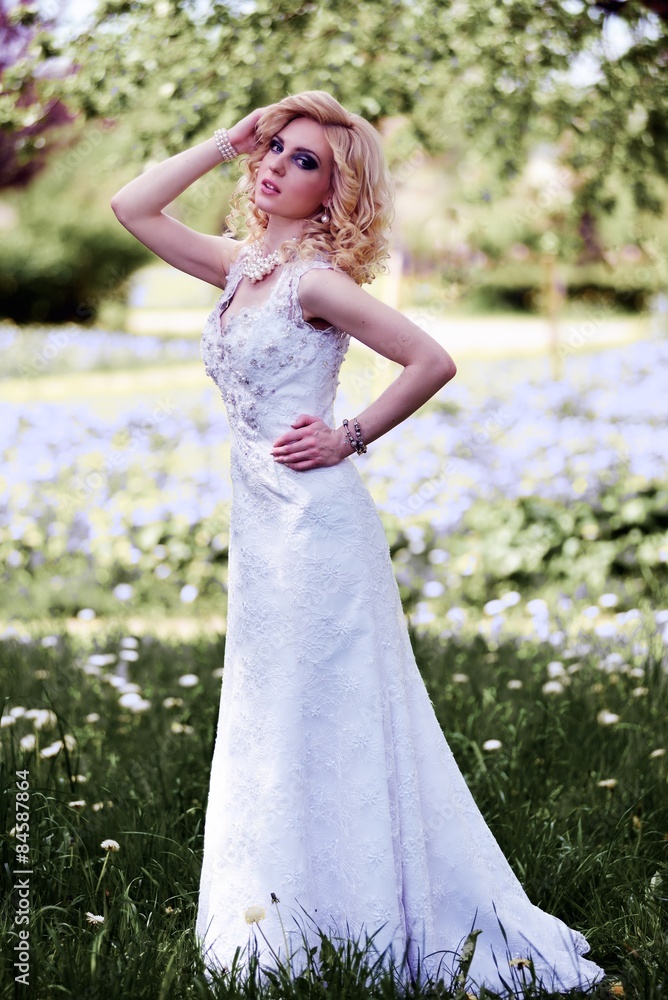 Beautiful young bride in white dress in summer green park Beautiful young bride in white dress in summer green park