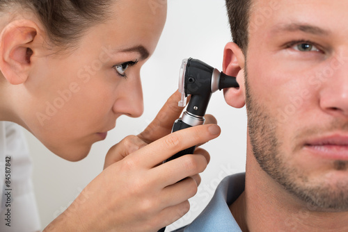 Doctor Examining Man's Ear