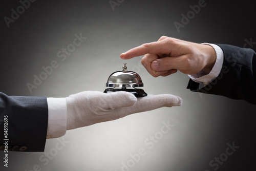 Obraz na plátně Close-up Of A Person's Hand Ringing Service Bell