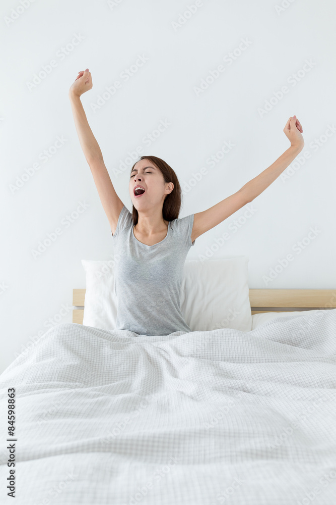 Woman wake up at morning and hand stretching Woman wake up at morning and hand stretching