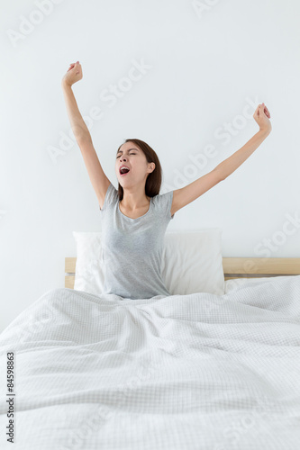 Woman wake up at morning and hand stretching