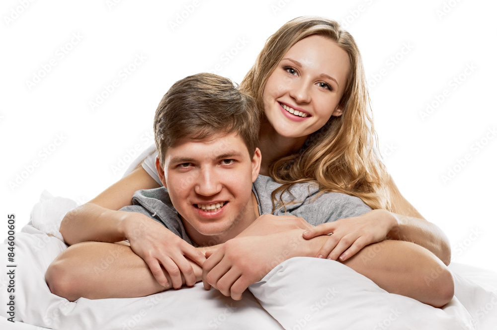 Couple lying in bed smiling Couple lying in bed smiling