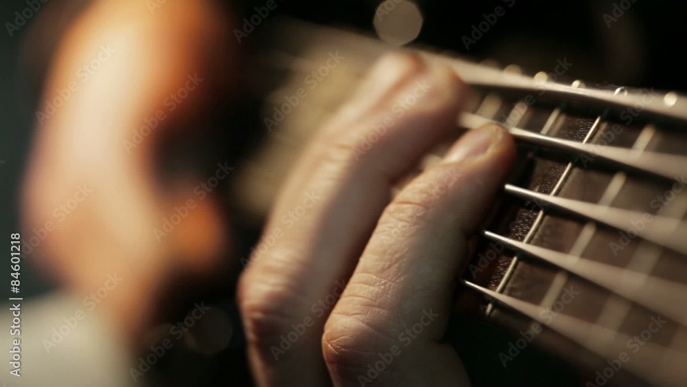 Musician playing five string electric bass guitar; cluseup Musician playing five string electric bass guitar; cluseup