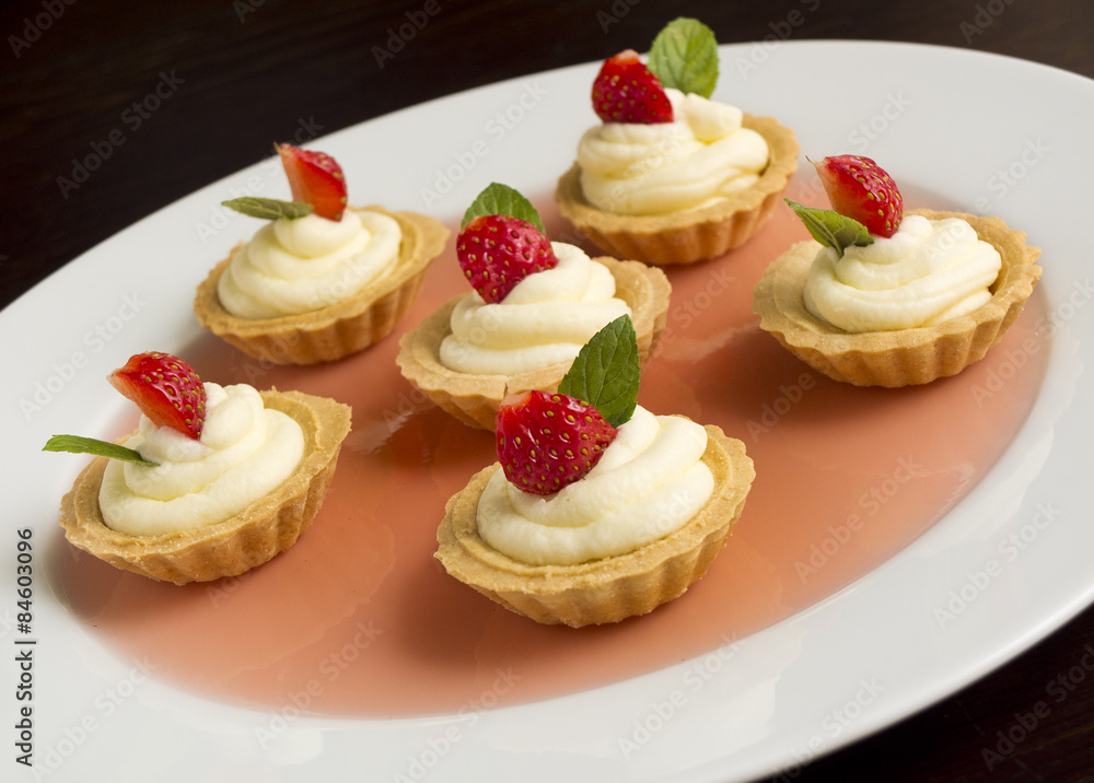 Cakes with strawberry, whipped cream, jelly and mint Cakes with strawberry, whipped cream, jelly and mint