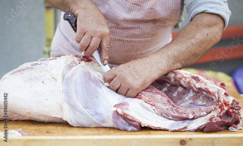 Butcher chopping meat