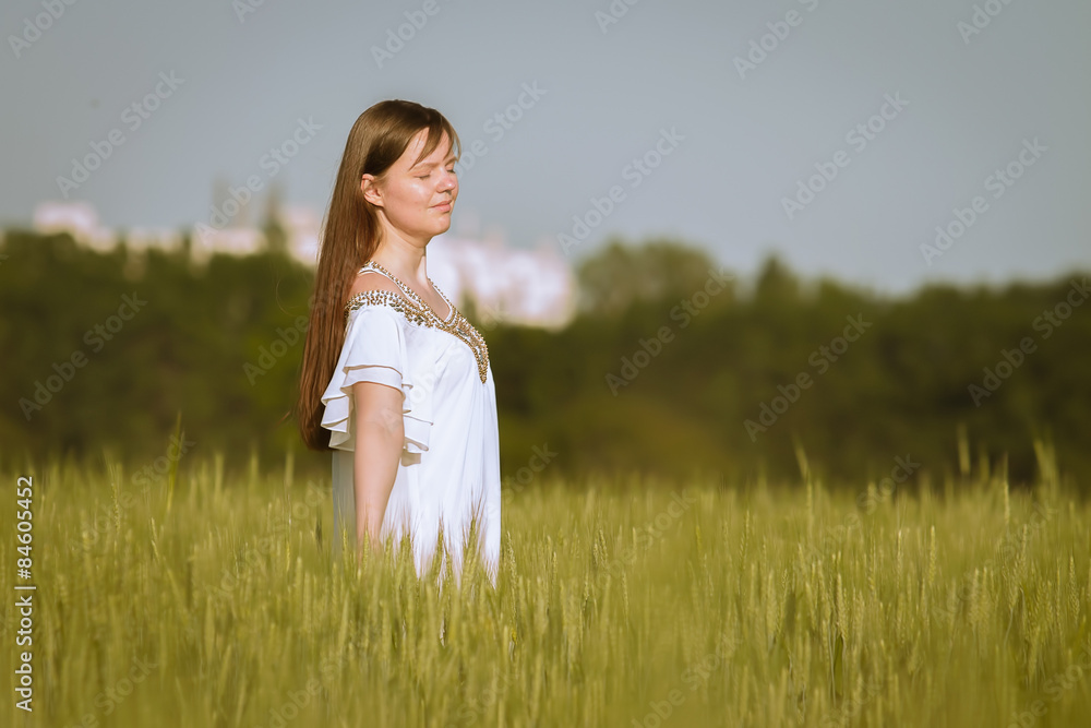 Woman hand touching wheat ears on the field Woman hand touching wheat ears on the field