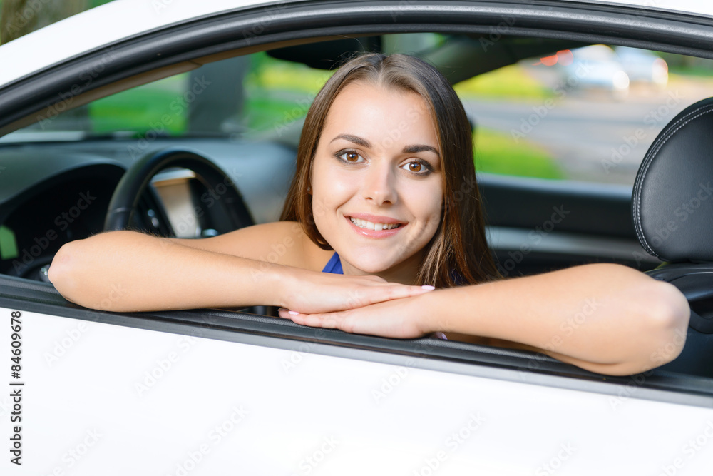 Portrait of girl leaning on car door