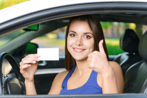Wallpaper Mural Attractive woman inside car showing card  Torontodigital.ca
