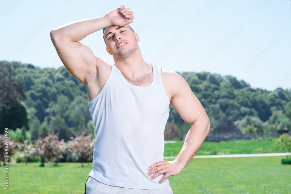 Handsome sportsman doing exercises outdoors