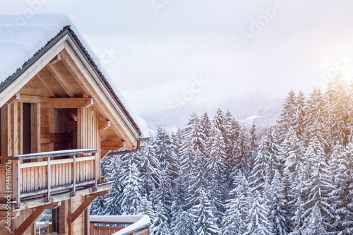 Chalet house in the mountains in winter photo