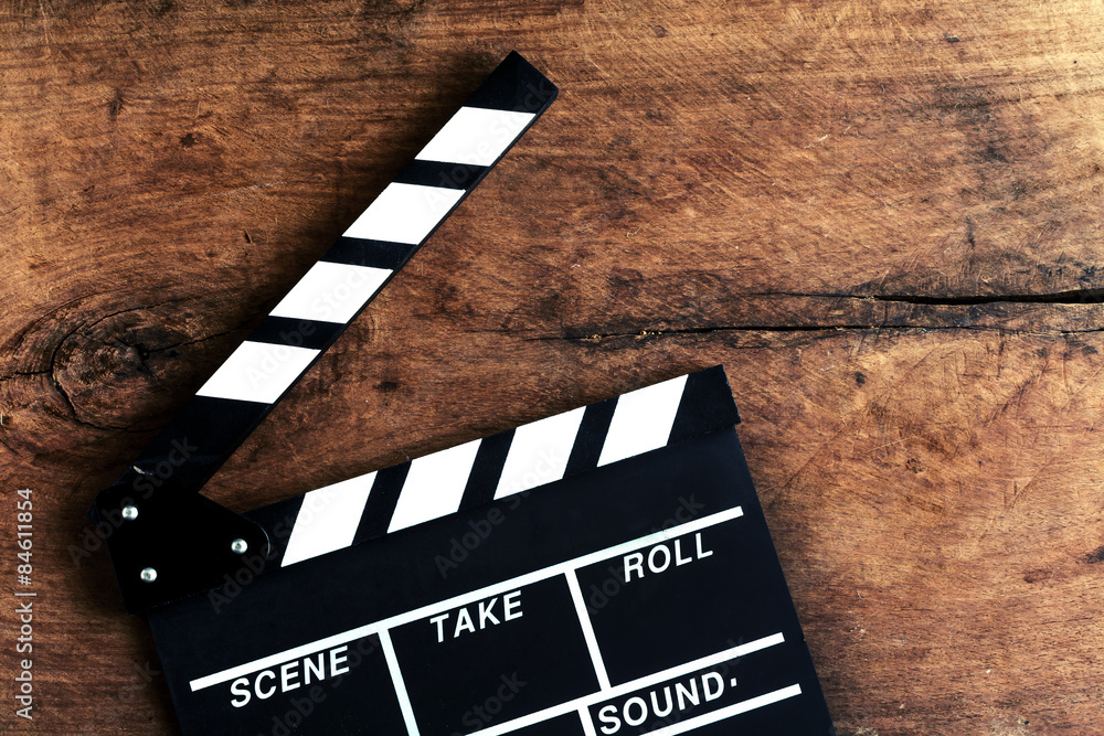 Movie clapper on old wooden background