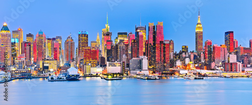 Panoramic view of Manhattan skyline with red sunlight reflection. #84613691