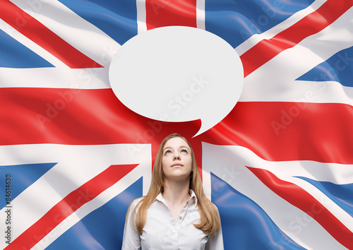 Beautiful woman and the blank speech bubble above the head. Great Britain flag as a background.