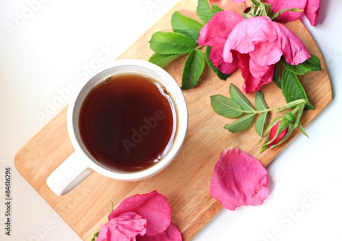 white cup on wooden tray healthy herbal rose hip tea fresh flowers 