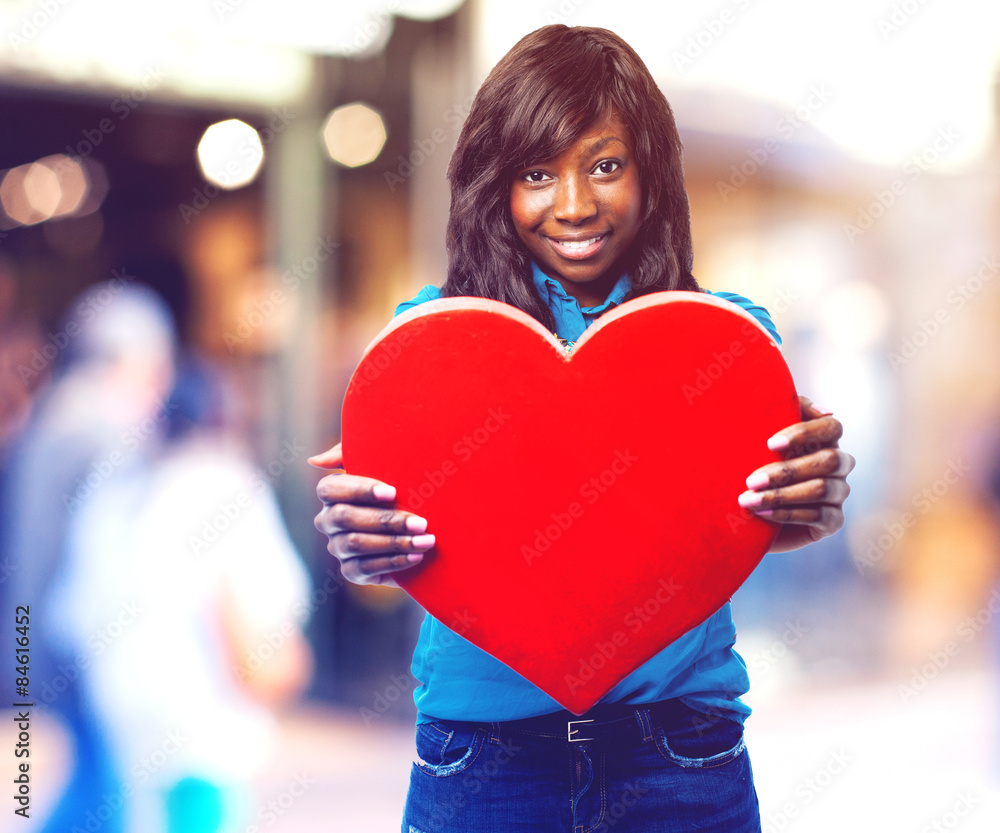 pensive black woman holding a heart pensive black woman holding a heart