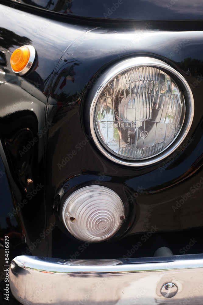 Italian style - detail of the headlight of an italian vintage car