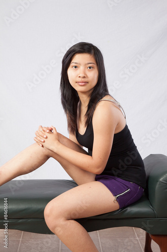 Thoughtful Asian woman sitting