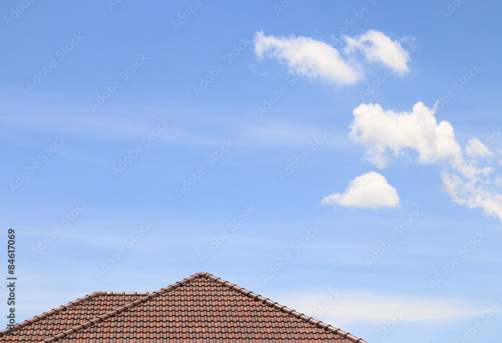 House brown brick roof, blue sky and cloud background.