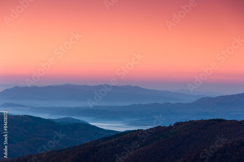 Beautiful landscape at dawn. Layers of mountain in pink light. © vovik_mar