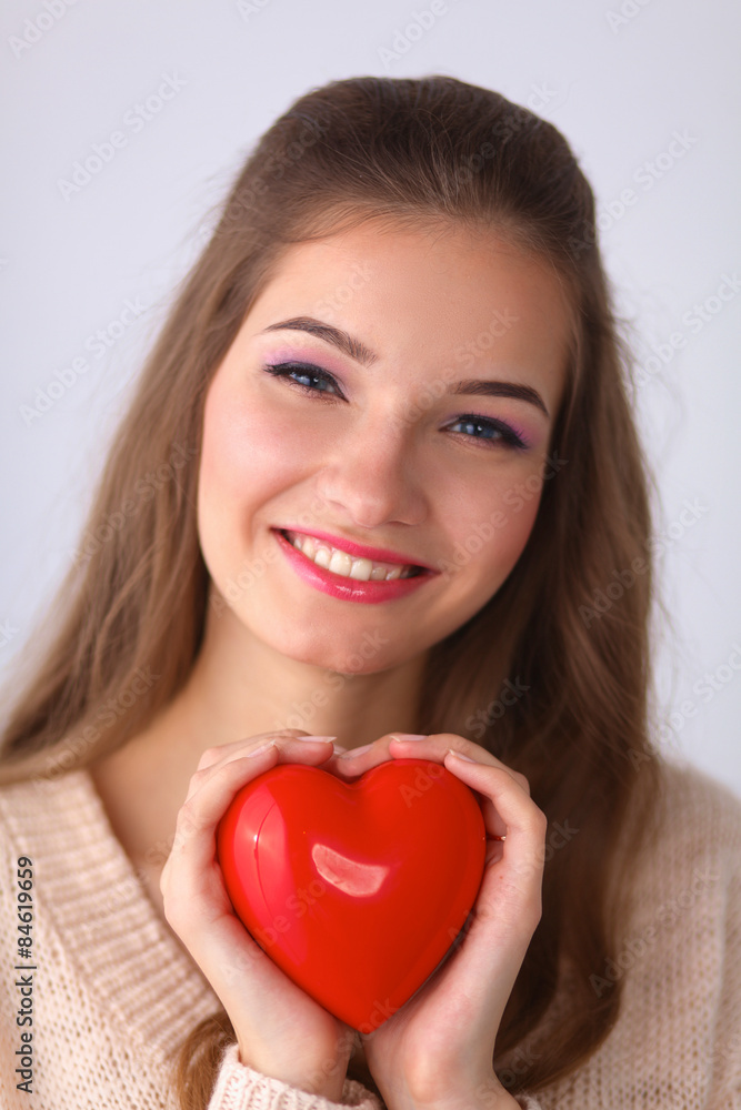 Portrait of beautiful happy woman holding a symbol heart. Portrait of beautiful happy woman holding a symbol heart.