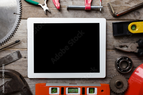 tools and tablet on a wooden table