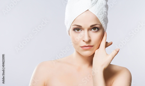 Young, beautiful and natural woman wrapped in towel