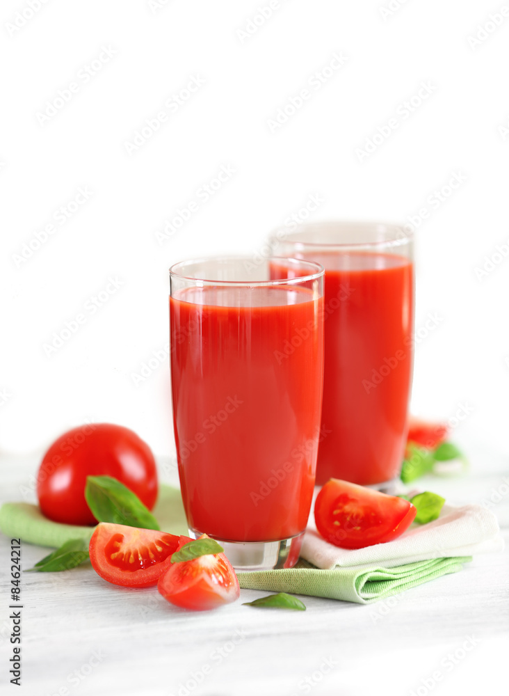 Tomato juice and fresh tomatoes on wooden table close-up Tomato juice and fresh tomatoes on wooden table close-up