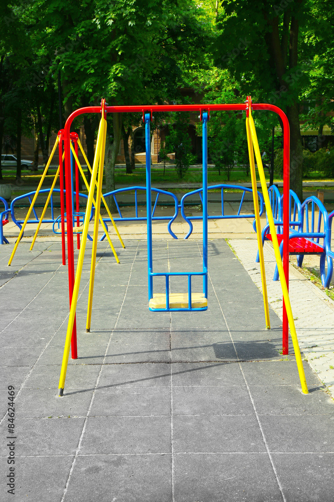 Empty chain swings on playground in public park Empty chain swings on playground in public park