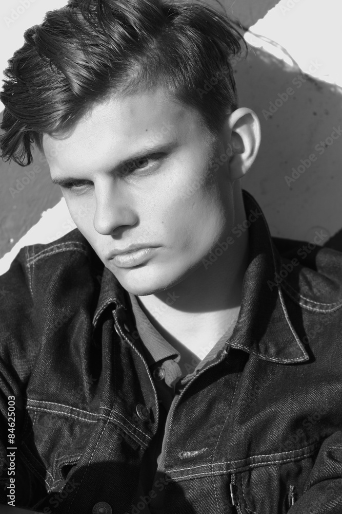 Obraz premium Stylish man sit in a denim jacket