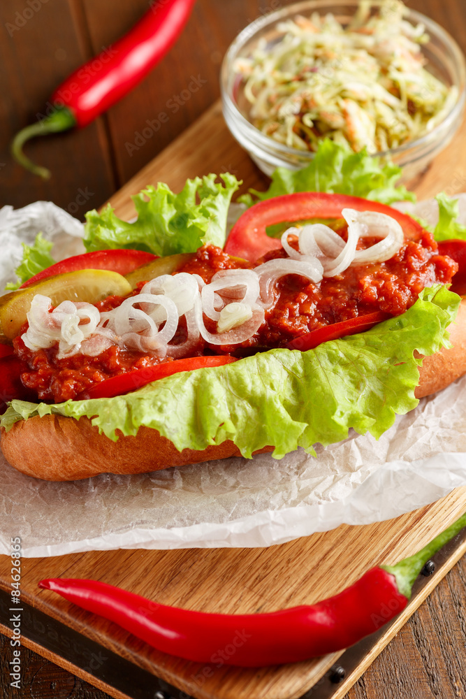 Hot-dog on wooden cutting board Hot-dog on wooden cutting board