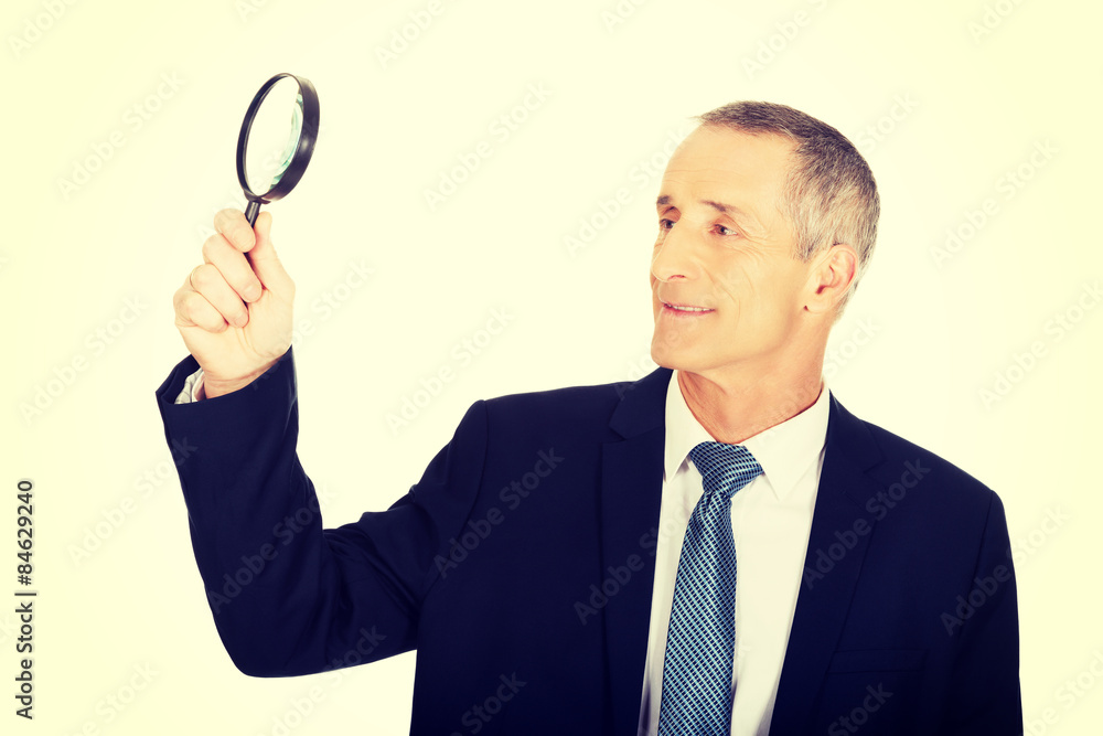 Portrait of businessman with a magnifying glass Portrait of businessman with a magnifying glass